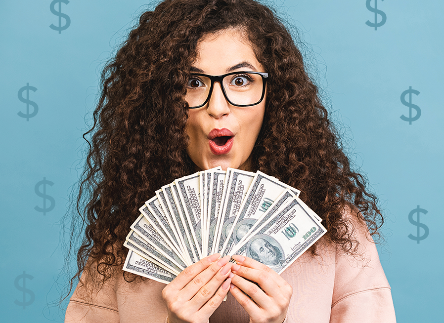 Woman with curly hair holding money